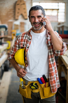 Carpenter Talking On Mobile Phone