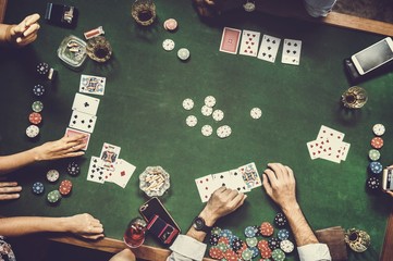 Group of people playing gambling together - obrazy, fototapety, plakaty