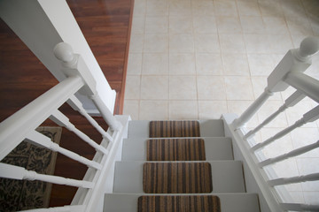 Looking down stair cast to tile floor