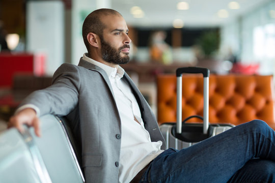 Thoughtful businessman sitting on chair in waiting area