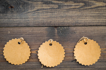 Figured blank tags for write price or discount on dark wooden background space for text mockup