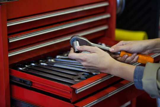 Hand of mechanic holding wrench