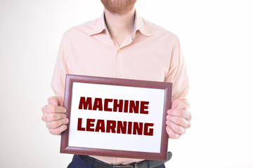 A businessman shows an inscription:MACHINE LEARNING