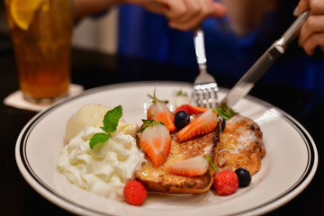Restaurant Concept. Asian women eating in restaurant. Asian women are happy to eat. Asian women relax in a restaurant. In the restaurant, Asian women are smiling happily.