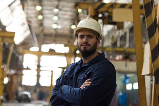 Portrait of confident technician standing with arms crossed