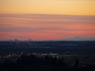 The Monviso and the skyscrapers of Milan from the walls of Bergamo during the sunset