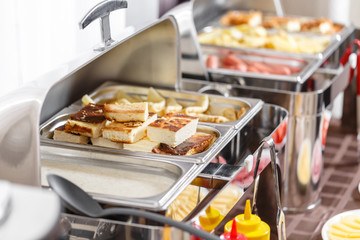 Buffet heated trays ready for service. Breakfast in hotel smorgasbord.