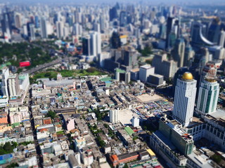Miniature Tilt shift lens effect of aerial view of midtown building in Bangkok.