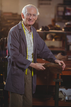 Portrait of shoemaker repairing a shoe