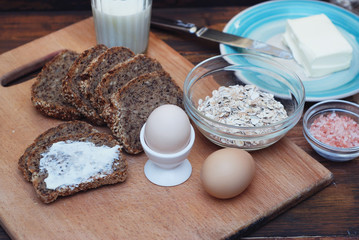 Healthy Breakfast. Fitness food. Eggs, Bread, Butter, Milk. Wooden Background. Flat Lay.
