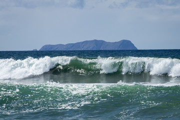 Waves Crashing and a Distant Island