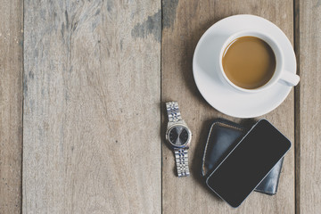 top view coffee  sunglasses with note book and smart phone on wood background