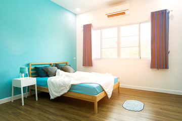 King-size bed in blue bright bedroom