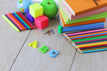 letters and school supplies on wooden background.photo with copy space