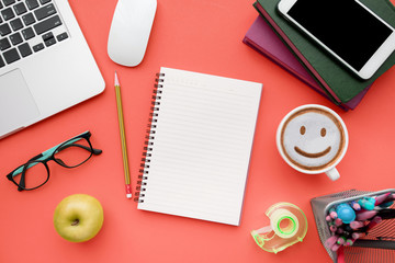 Top view, flat lay of Modern red office desk table with laptop