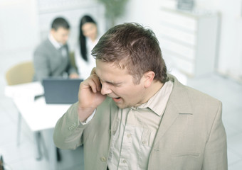 Fototapeta premium closeup.Manager talking on mobile phone in office