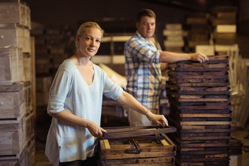 Workers working on hive frames in warehouse