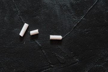 A few pieces of white chalk lie on the board for writing your own work. DIY. Hand made. Copy space.. © AnastazjaSoroka