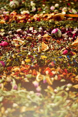 Close up tea background: green, black, floral, herbal, mint, melissa, ginger, apple, rose, lime tree, fruits, orange, hibiscus, raspberry, cornflower, cranberry. Assortment of dry tea, top view