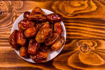 Date fruits on a wooden table. Top view