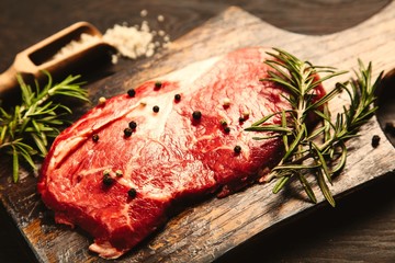 Raw steak on a wooden cutting board