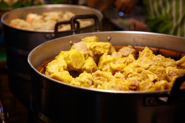 Chiang Mai, Thailand - April 8, 2018 : Street food (Pork Dumpling with steam) at the Sunday Night Market Walking Street on April 8, 2018 in Chiang Mai, Thailand. Selective focus.