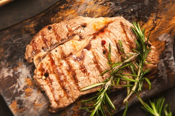 Grilled steak on wooden cutting board