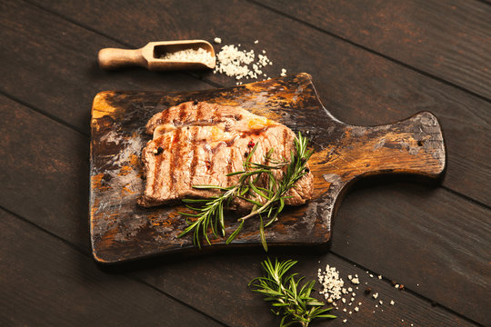 Grilled steak on wooden cutting board