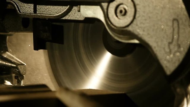 Industrial hand circular saw. saw at work cutting a wooden lath