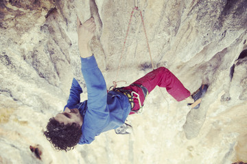 Rock-climbing in Turkey. The climber climbs on the route. Photo from the top.