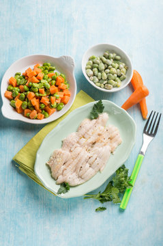 sole fish with carrot, green beans and broad beans salad