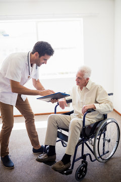 Nurse showing senior man a document