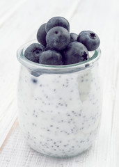 chia smoothie with berries on white wooden board