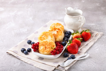 Cottage cheese pancakes with berries. Selective focus. Russian cheesecakes. Copy space