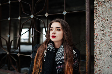 Fototapeta premium Brunette stylish casual girl in scarf against abandoned factory place.