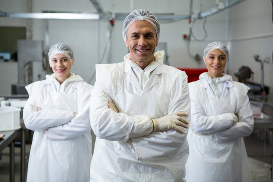 Butchers standing with arms crossed