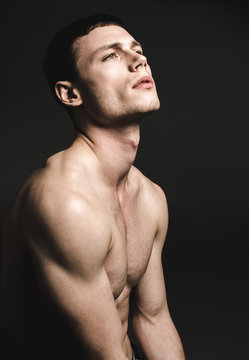 Side view contemplative young man with attractive body watching directly