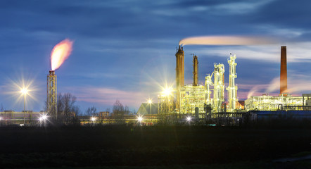 Fototapeta na wymiar Oil Refinery at night with smoke stack