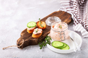 Spread from red fish in jar on a table