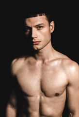 Obraz premium Portrait of confident male stripped to waist. He isolated on black background. Assurance concept