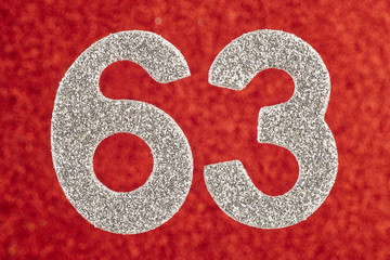 Number sixty-three silver color over a red background. Anniversary