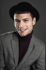 Portrait of cheerful young employer looking at camera while isolated on black background. Happy male concept