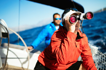 Attractive strong woman sailing with her boat