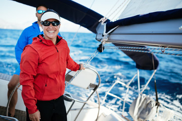 Attractive strong woman sailing with her boat