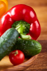 Composition of vegetables on flat plate on wooden table, close-up, selective focus