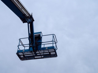 Human basket attached to end of crane