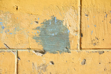 Worn and weathered crusted chipped paint on textured cement