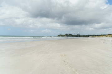empty coastline under blue sky with clouds, Rarawa beach, New Zealand