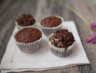 Tasty chocolate muffins on white kitchen table. 