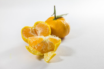 Fresh fruit, fresh tangerine, split white background